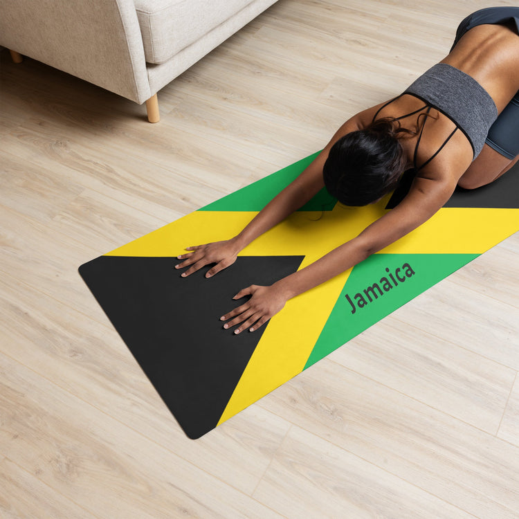 Woman doing child's pose on a Jamaican Flag inspired yoga mat.